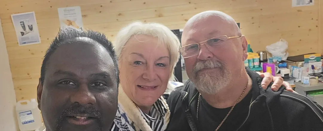 Ray taking a selfie with two smiling patients in the clinic